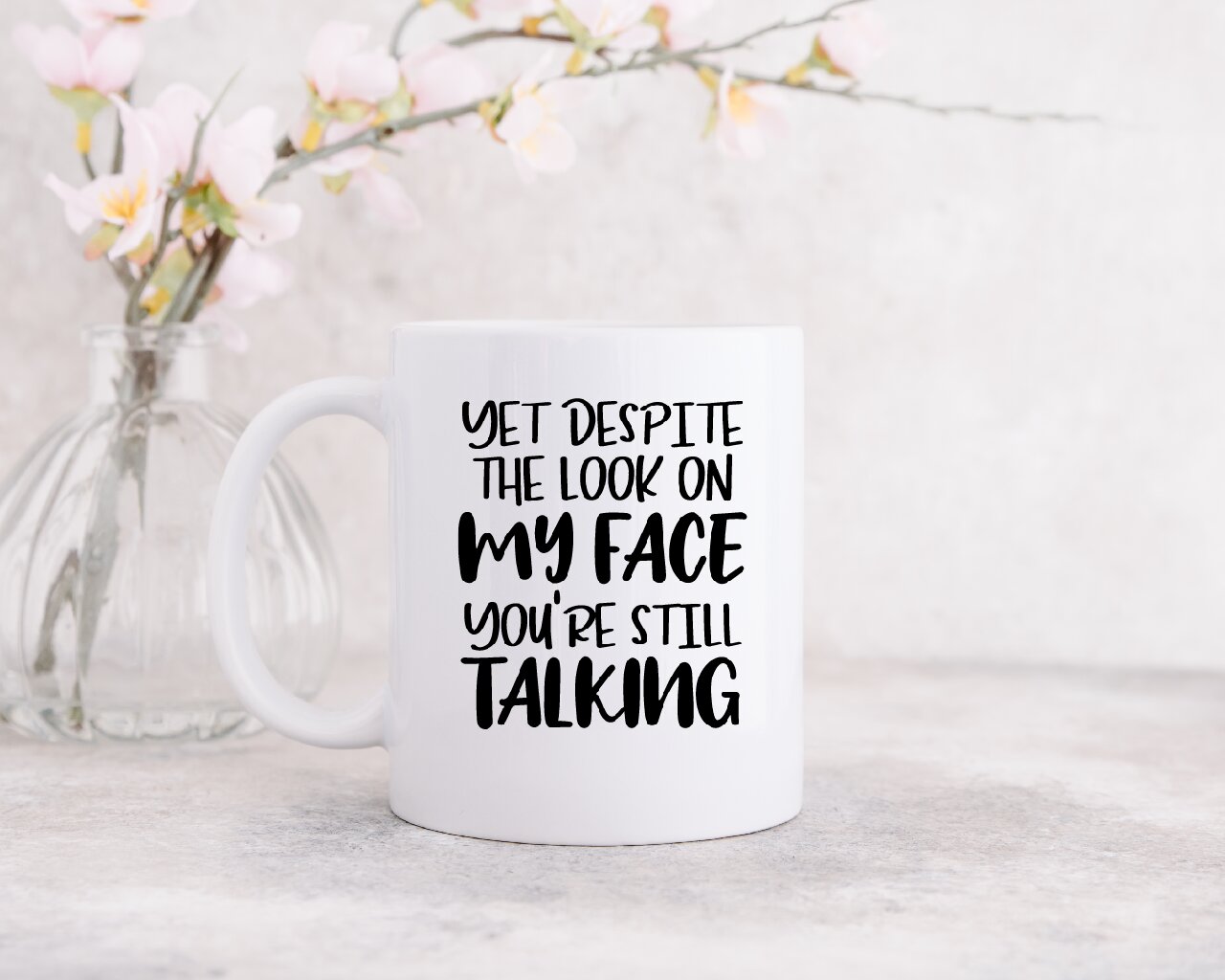 Yet Despite The Look On My Face, You're Still Talking -  Coffee Mug